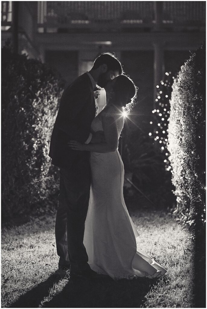 Bride and Groom in Silhouette sharing a kiss.Photo taken by Dripping Springs TX based Lydia Teague Photography. 