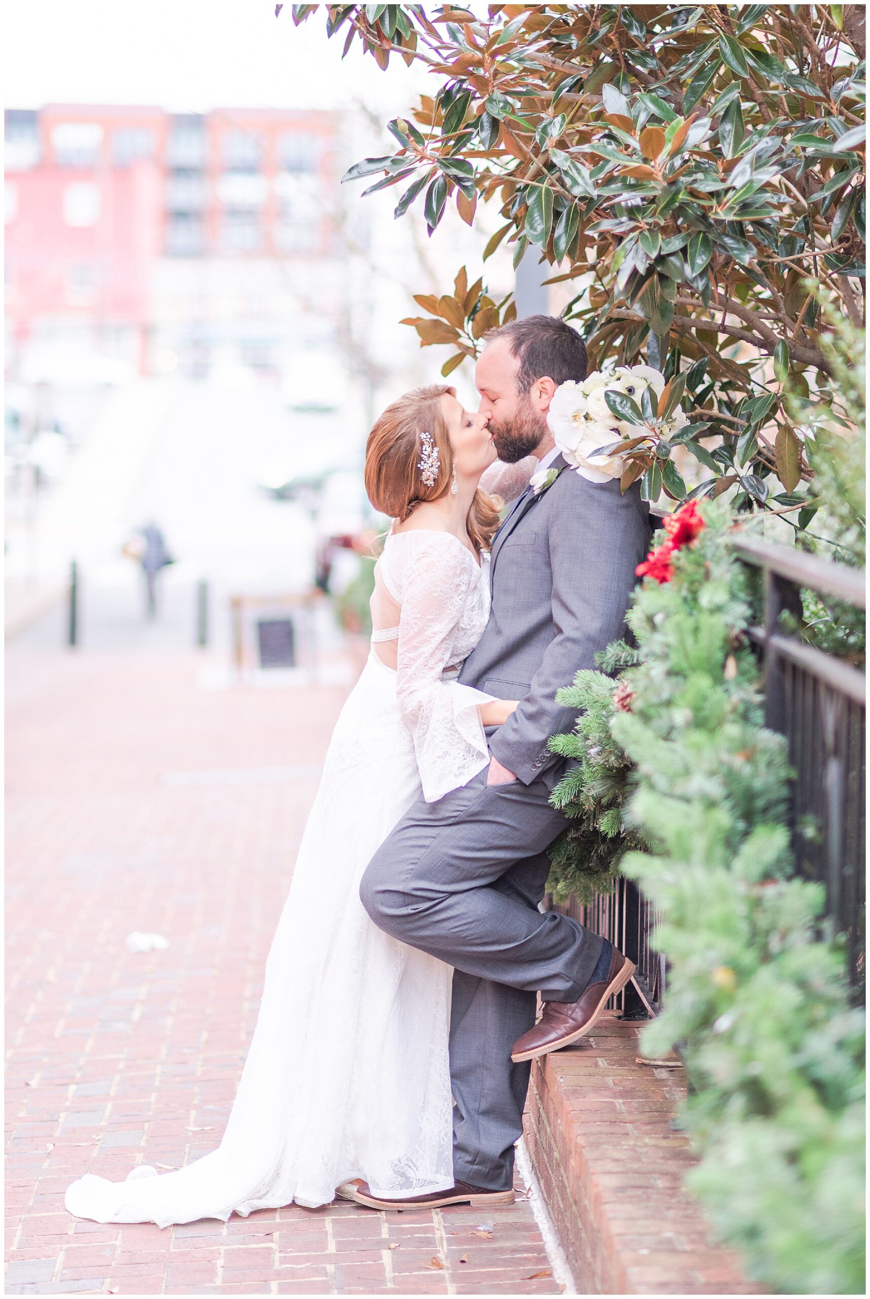 Couple sharing a kiss in Charlottesville, Virginia during the wintertime at the Downtown Mall.