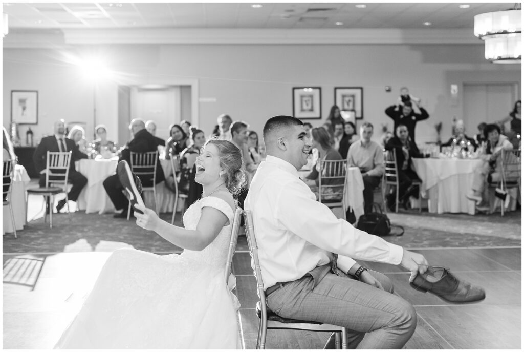 Bride and Groom playing the shoe game at their Wedding Reception. Photo taken by Dripping Springs TX based Lydia Teague Photography. 