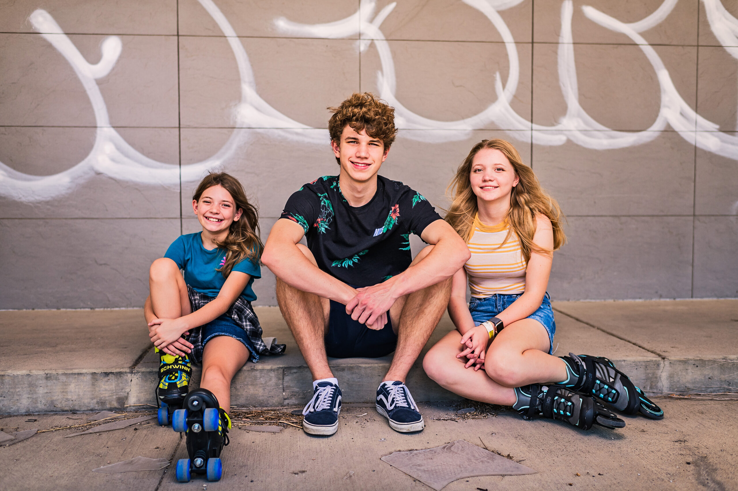 Abandoned fast food spot with graffiti is the backdrop for a skating themed teen/tween photo session. Taken by Lydia Teague Photography.