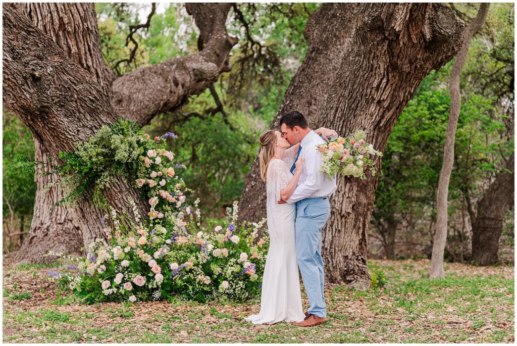 Wedding under Live Oak trees with a beautiful wild whimsical floral arrangement in pastels. Photo taken by Dripping Springs based Lydia Teague Photography. 